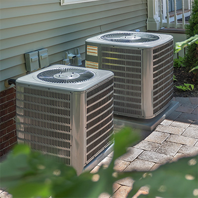 two HVAC units in someones yard